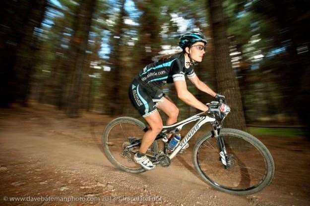 Vanessa Boatwright (Altitude Training Systems) rails the downhills as the dense pine forest becomes but a blur.